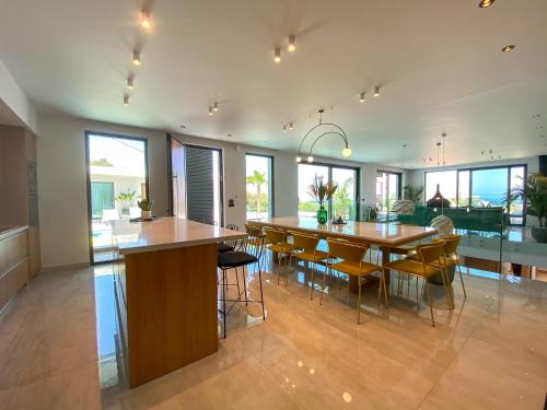 a kitchen and dining room with a table and chairs at Villa Lydia I Superb views, two pools, next to the city in Kissamos
