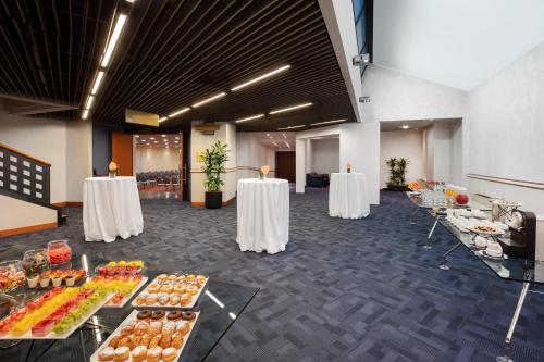 a banquet hall with tables with food on them at Crowne Plaza Milan Linate, an IHG Hotel in San Donato Milanese