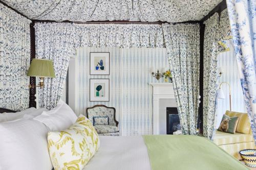 a bedroom with a bed and a fireplace at The Mayflower Inn & Spa, Auberge Collection in Washington
