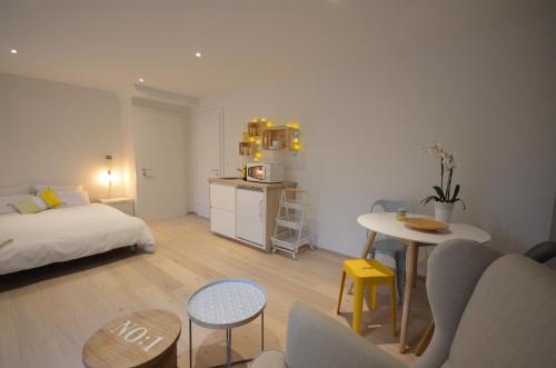 mały salon z łóżkiem i stołem w obiekcie La Chambre #11 w mieście Preverenges