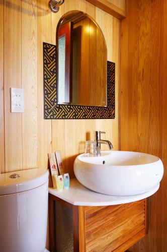 a bathroom with a white sink and a mirror at Oriental Sails Cruise in Ha Long
