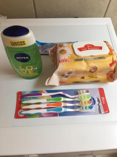 a drawer filled with toothbrushes and a cup of coffee at Central apartment in Pristina