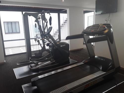 a room with a gym with a treadmill at Hotel Bristol in Mexico City