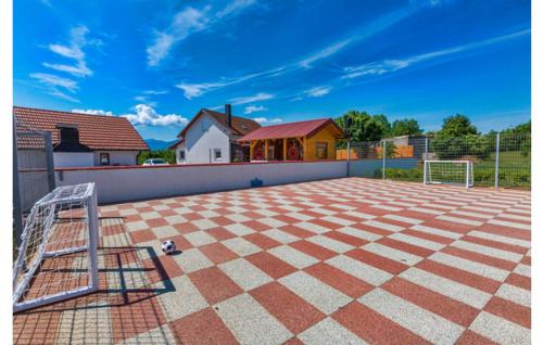 a tiled patio with a soccer ball and a goal at Vila NINA in Gospić