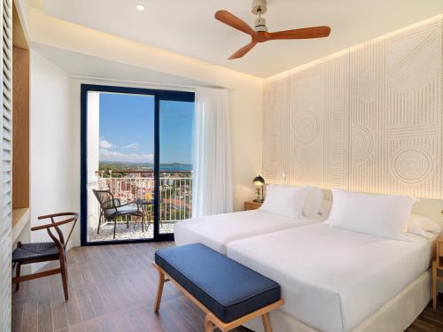 a hotel room with two beds and a balcony at H10 Imperial Tarraco 4 Sup in Tarragona