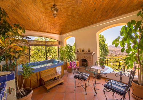 a large room with a hot tub on a patio at Casa Estrella de la Valenciana Hotel Boutique in Guanajuato