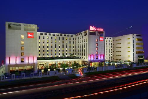 a building with a sign on top of it at night at ibis New Delhi Aerocity - An Accor Brand in New Delhi