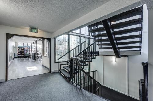 a hallway with a spiral staircase in a building at Days Inn & Suites by Wyndham Spokane in Spokane