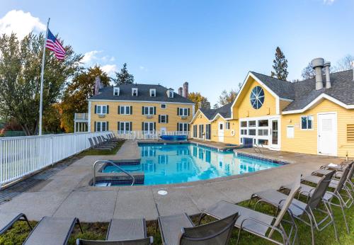 a house with a swimming pool in the yard at The Bethel Inn Resort in Bethel
