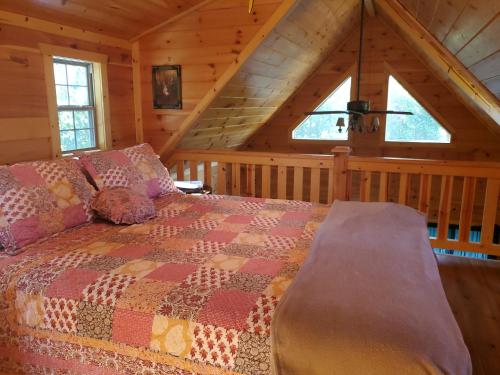 a bedroom with a bed in a cabin at The Frontier - An Amish Built Deluxe Cabin in Genoa
