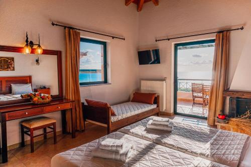 a bedroom with a bed and a desk and a window at Natura Club Hotel & Spa - Adults Guests in Kyparissia