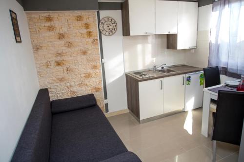 a living room with a couch and a kitchen at Apartments Vukman in Trogir