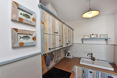 a bathroom with wooden cabinets and a sink at Romana Serena Sunset in Vrsar
