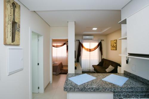 a kitchen and living room with a counter top in a room at Flats Andira Kuss in Sinop