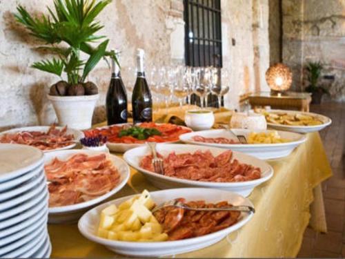 a buffet with many plates of food on a table at I Costanti in Caldiero