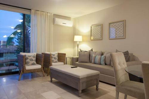 a living room with a couch and chairs and a table at Departamentos San José in La Paz