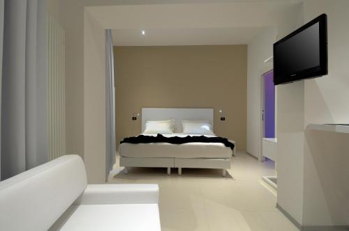 a bedroom with a bed and a flat screen tv at Hotel Metropolitan in Bologna
