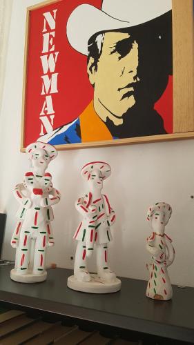 two white figurines sitting on a shelf with a painting at Hostal Ca'n Tiu in Alaró