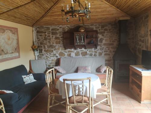 La Casa Del Llano في Olocau del Rey: غرفة طعام مع طاولة وكراسي وأريكة