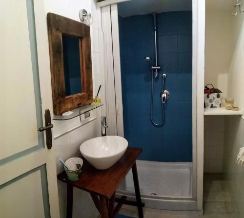 a bathroom with a sink and a shower at Appartamento Palma Gold in Spello