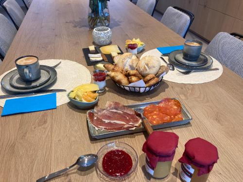 a wooden table with food on top of it at B&B Waterput 1 in Stalhille