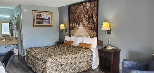 a hotel room with a bed and a telephone at Palmetto Inn in Estill