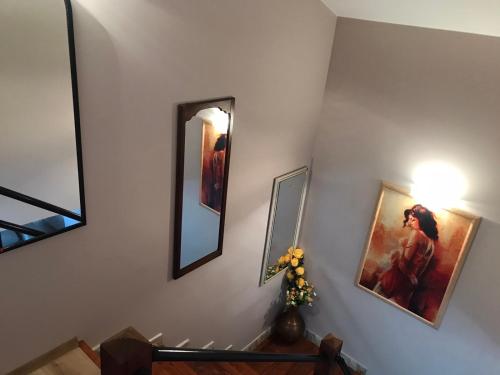 a hallway with two mirrors and a table with flowers at Guest House Kalina in Sapareva Banya