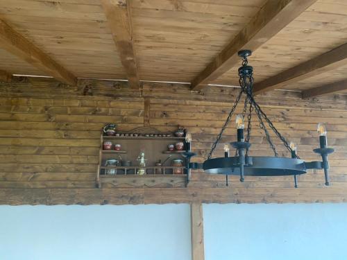 a chandelier hanging from a ceiling in a room at Guest House Kalina in Sapareva Banya