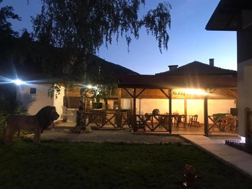 a horse standing in front of a house at night at Guest House Kalina in Sapareva Banya