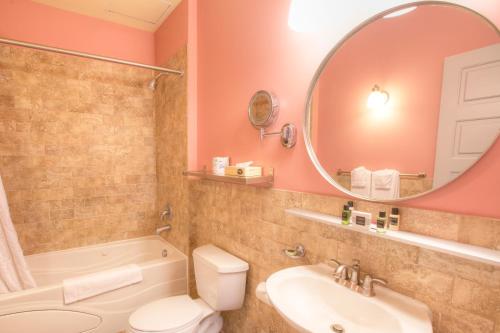 a bathroom with a sink toilet and a mirror at Montvale Hotel in Spokane