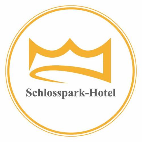 a yellow swiss embassy hotel logo in a circle at Schlosspark-Hotel Hof von Oldenburg in Rastede
