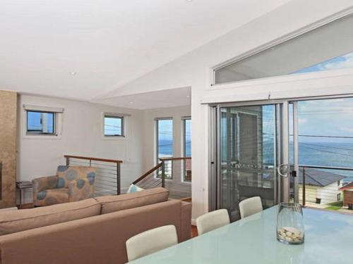 a living room with a couch and a table at Surf Mist in Gerroa