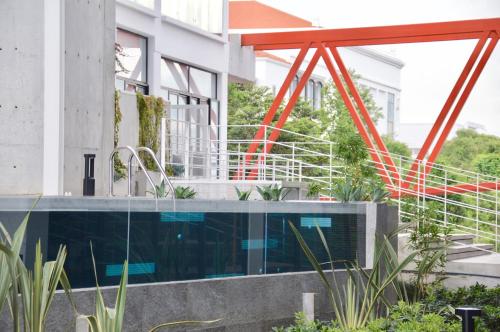 an external view of a building with a swimming pool at Cozy Stays Cayala Apartments 2 in Guatemala