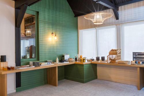 a green room with a counter and some windows at Sure Hotel by Best Western Argentan in Argentan