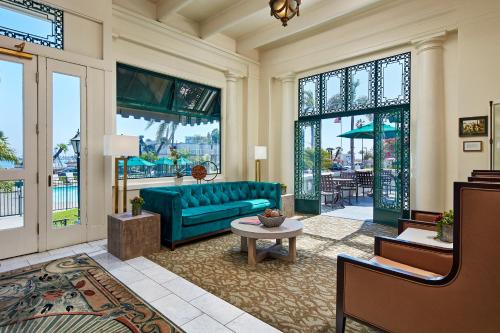 a living room filled with furniture and a large window at Glorietta Bay Inn in San Diego
