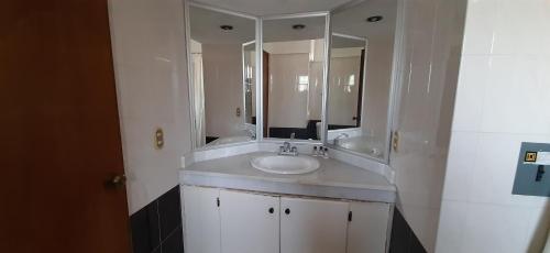 a bathroom with a sink and a mirror at Hotel San Miguel in Autlán de Navarro