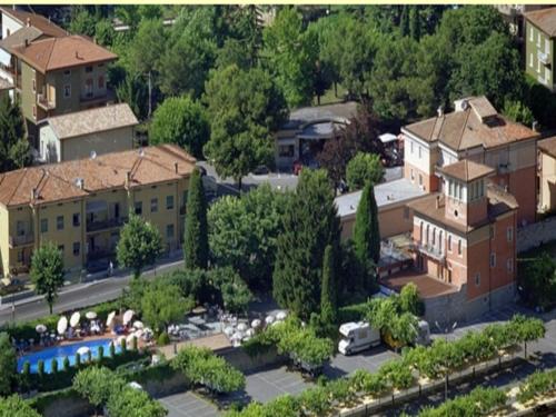 arial view of a city with buildings and trees at Hotel Villa Mulino ***S in Garda