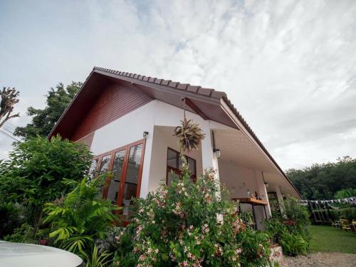 a small house with a lot of plants at CoZy House Chiangrai in Chiang Rai