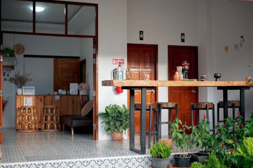 a room with a bar in a building with plants at CoZy House Chiangrai in Chiang Rai