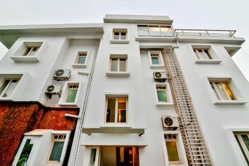 a white apartment building with a fire escape at Casabela Boutique Hotel in Porvorim