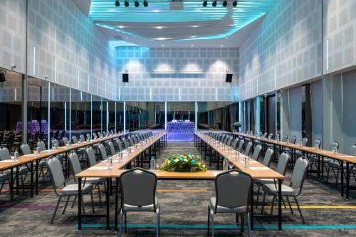 a large conference room with long tables and chairs at VELA Dhi Udon Thani in Udon Thani