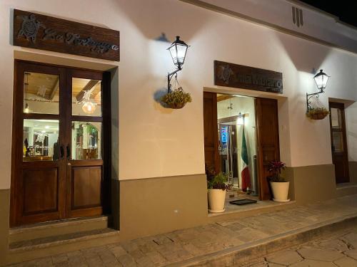 a store front with two doors and two windows at Hotel Villa Murano in San Cristóbal de Las Casas