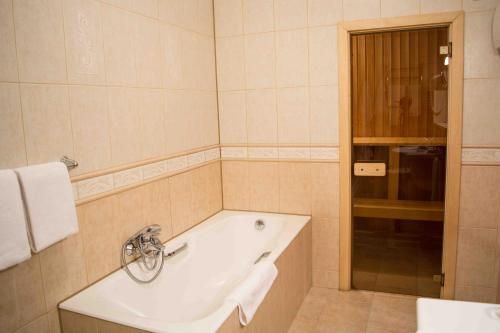 a bathroom with a tub and a sink at Hotel Kupechesky in Krasnoyarsk