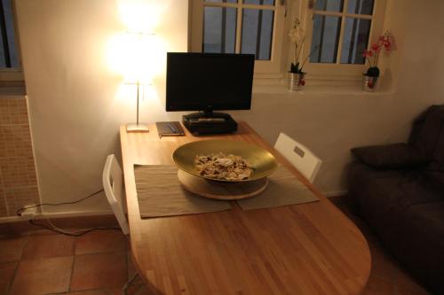 a wooden table with a bowl on top of it at La Loge Du Vieux Lyon in Lyon
