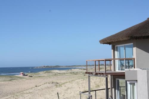 a beach house with a view of the ocean at MarAdentro Apart Hotel & Suites in Punta Del Diablo