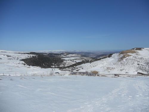 a view of a snow covered field with a mountain at Château de la Moissetie in Aurillac