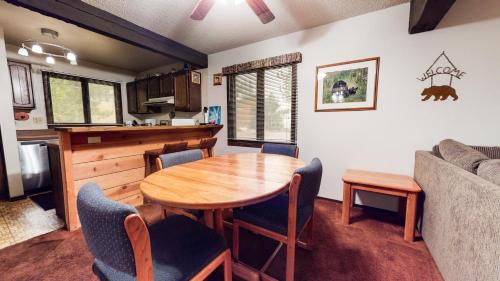 a kitchen and dining room with a wooden table and chairs at Wild Flower 37 Apartment in Mammoth Lakes