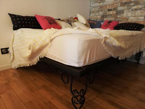 a bed with a white comforter and pillows at Maison Small Luxury ( planxa,suite,solarium,jacuzzi,pas de vis à vis) in Argelès-sur-Mer