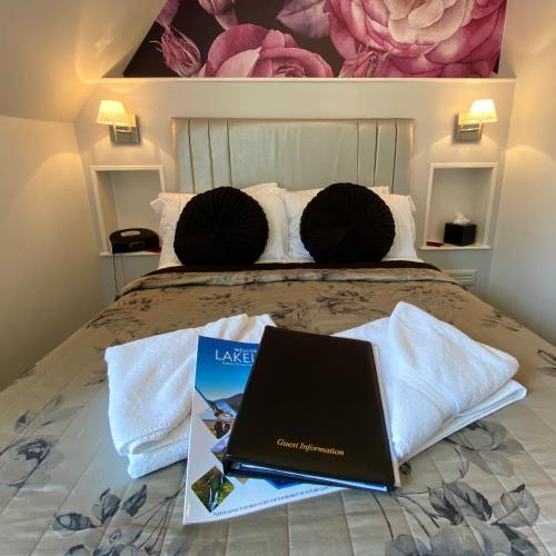 a laptop computer sitting on top of a bed at Dene House Guest House in Bowness-on-Windermere