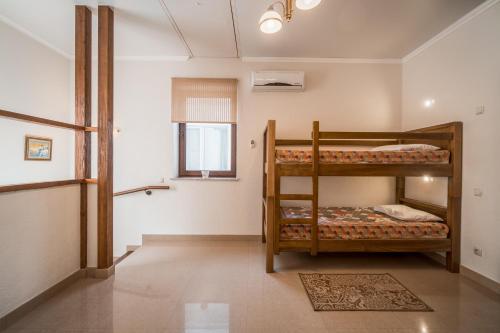 a room with two bunk beds and a window at Villa Bugaz in Zatoka